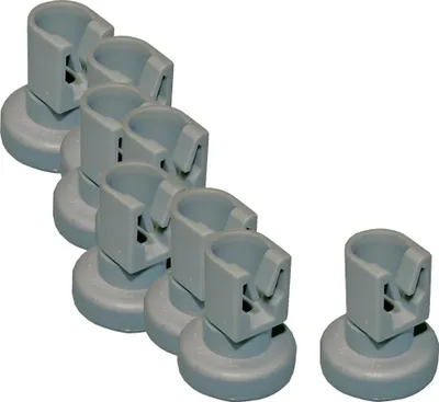 A group of gray plastic dishwasher basket rollers arranged in a diagonal line, with one roller separate from the group.