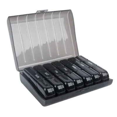 An open pill organizer with seven individual compartments, each labeled with a day of the week.
