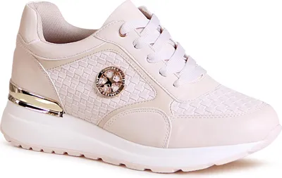 A studio shot of a single beige wedge sneaker.