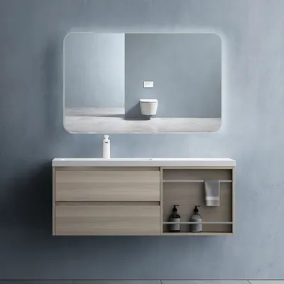 A modern bathroom vanity with a sink and mirror against a blue wall.