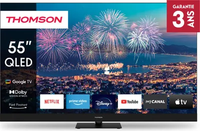 A Thomson 55" QLED TV displaying a city skyline with fireworks, with various app logos at the bottom.