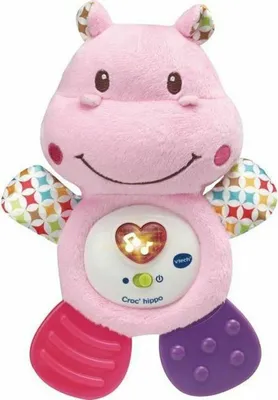 A pink plush hippo toy with a light-up heart on its belly.