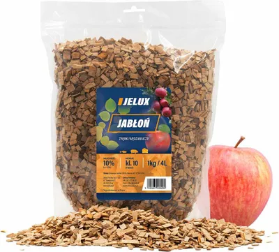 A bag of wood chips for smoking, with an apple and some leaves on the label, and a real apple next to it.