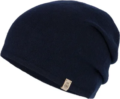 A dark blue beanie hat with a small tan tag on the side.