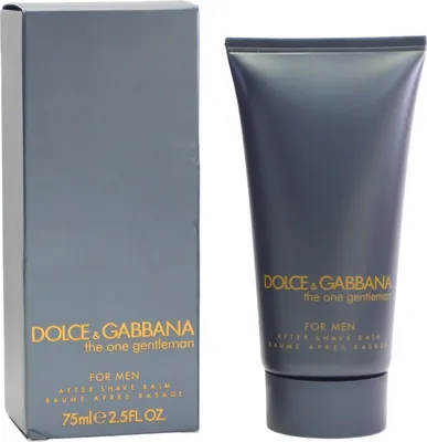 Dolce & Gabbana The One Gentleman After Shave Balm in dunkelgrauer Tube mit goldener Schrift, stehend neben passender Verpackung