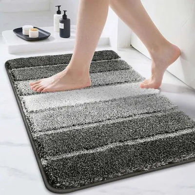 Immagine prodotto di Tappetino antiscivolo da bagno Unyqoos® – realizzato in morbida microfibra al 100%, assorbente e lavabile in lavatrice, dimensioni 50 x 75 cm, colore grigio scuro, base in TPR antiscivolo