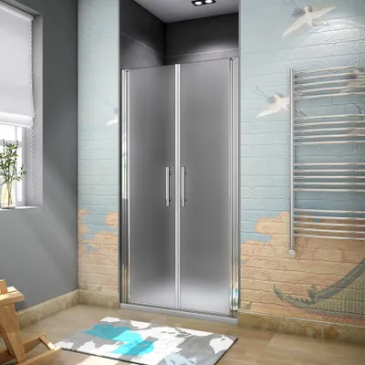A modern bathroom with a frosted glass shower enclosure, a towel rack, and decorative wall art.