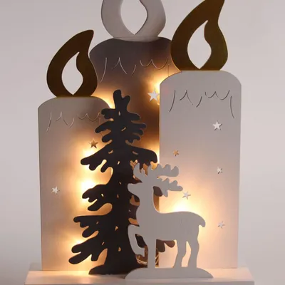 A wooden Christmas decoration featuring three candle shapes, a Christmas tree, and a reindeer, illuminated by warm LED lights.