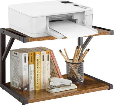 A two-tier desk organizer with a printer on the top shelf and books, pencils, and a stapler on the bottom shelf.
