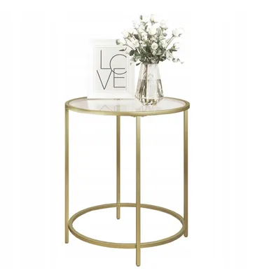 A gold side table with a glass top, decorated with a vase of white flowers and a framed picture with the word 'LOVE'.