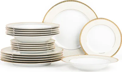 A set of white porcelain dinnerware with gold trim is neatly stacked and arranged against a white background.