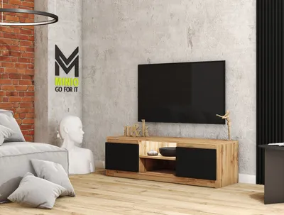 A modern living room with a TV stand, sofa, and decorative elements.