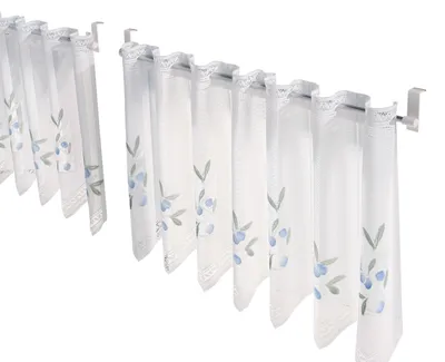 Two sets of cafe curtains with a blue floral pattern hanging on curtain rods.
