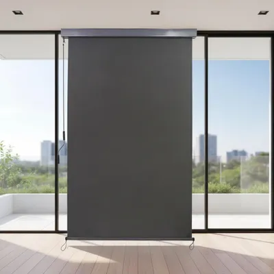 A dark gray roller blind is installed on a large window overlooking a city skyline and greenery.