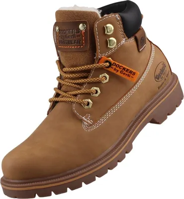 Das Bild zeigt einen gelben Stiefel der von der Seite betrachtet wird. Die Sohle und der obere Rand des Stiefels sind deutlich sichtbar während das Material glatt und glänzend erscheint.