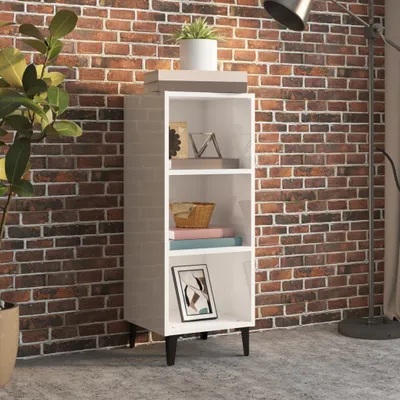 A white bookcase against a brick wall.