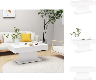 A white coffee table is placed in a modern living room setting with a sofa, armchair, and a plant.