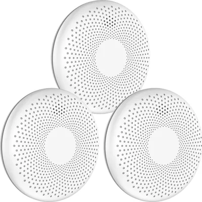 Three white, circular smoke and carbon monoxide detectors are arranged in a cluster against a white background.
