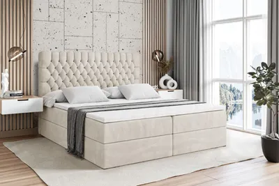 A bedroom scene featuring a large, tufted bed.