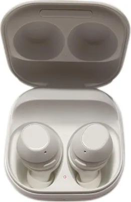 A pair of white wireless earbuds in their charging case.