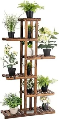 A multi-tiered wooden plant stand filled with various potted plants.