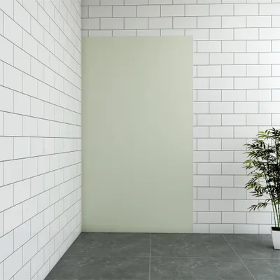 A corner of a room with white tiled walls and a light green panel.