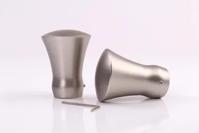Two curtain rod finials and an Allen wrench on a white background.