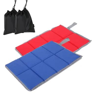 Two foldable seat cushions, one blue and one red, are shown with two black drawstring bags in the background.