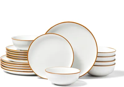 A set of white ceramic plates and bowls with brown rims, stacked and arranged on a white background.