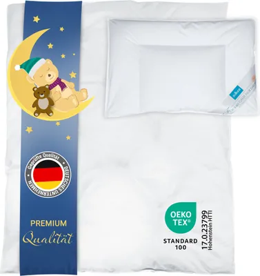 A white duvet and pillow set for children, with a decorative blue band featuring a sleeping bear on the moon and stars.