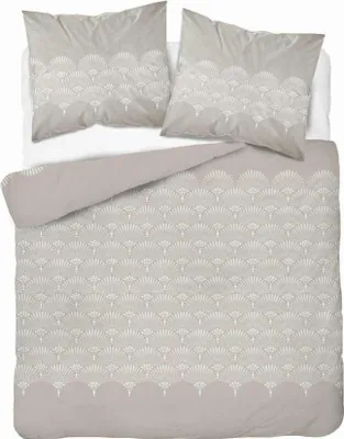 A neatly folded duvet and two pillowcases with a fan-like pattern are laid out on a bed.