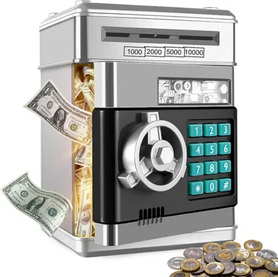 A product shot of a silver and black automatic piggy bank with a keypad and a vault-like door, with dollar bills sticking out and coins scattered at the bottom.