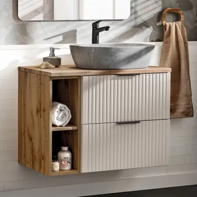 A bathroom vanity with a sink and faucet.