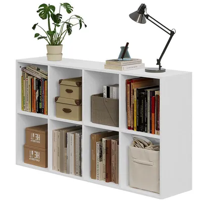 A white modular shelving unit filled with books, decorative boxes, and a storage bin.