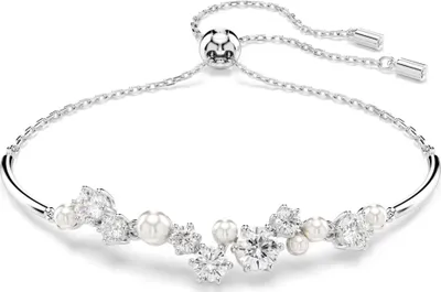 A close-up studio shot of a silver-colored bracelet with pearls and crystals.