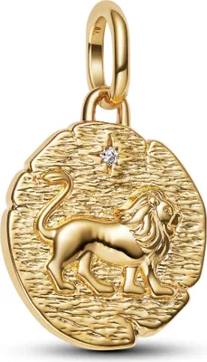 A gold pendant with a lion engraving and a small diamond.