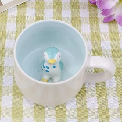 Immagine prodotto di Tazza da caffè 3D, design pinguino, stile cartone animato, materiale Vetroceramica, capacità 12 once, con sorpresa sul fondo