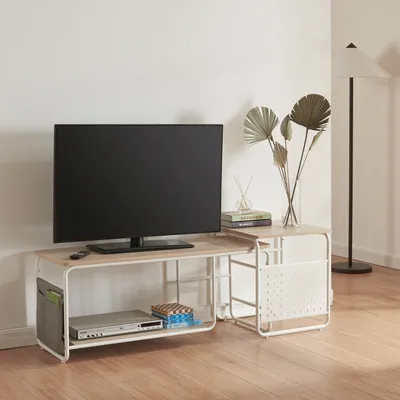 A TV stand with a TV and accessories in a room.