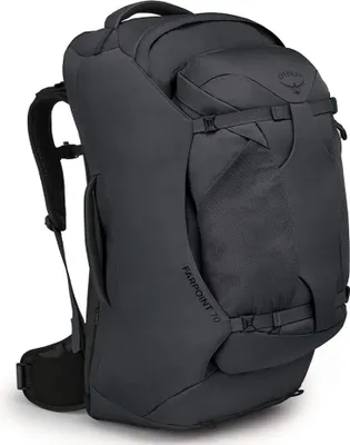 A dark gray Osprey Farpoint 70 travel backpack is shown from a three-quarter side view against a light gray background.