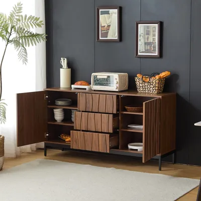 A dark brown sideboard with open doors and drawers, displaying kitchenware and food items, set in a room with dark gray walls and a light gray rug.