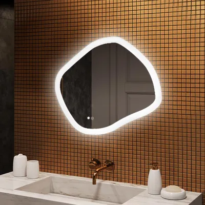 A modern bathroom vanity with a sink, faucet, and a uniquely shaped LED mirror mounted on a tiled wall.