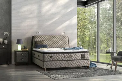 A bedroom scene with a bed, nightstand, and a large window overlooking a garden.