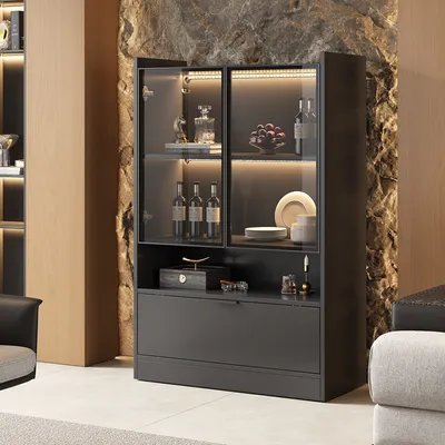 A modern sideboard with glass doors and interior lighting, showcasing decorative items and bottles.