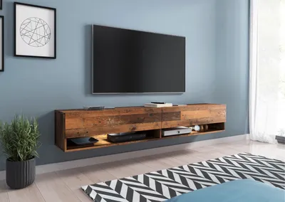 A modern living room with a wall-mounted TV stand and a large television.