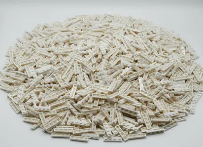 A pile of white LEGO bricks on a white background.
