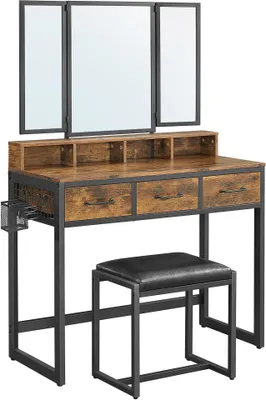 A vanity table with a tri-fold mirror and a stool, set against a white background.