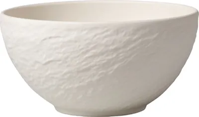 A white ceramic bowl with a textured exterior.
