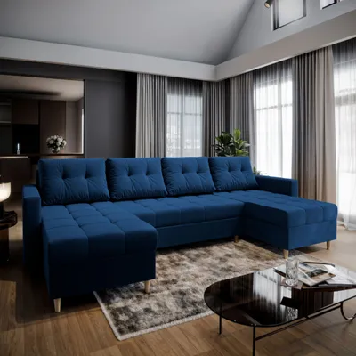 A spacious living room with a large blue sectional sofa, coffee table, and curtains.