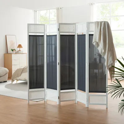 A room divider is set up in a bedroom, partially obscuring a bed and dresser.
