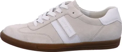 A side view of a beige sneaker with white laces and white accents.